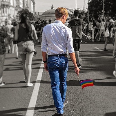 student walking in pride parade.