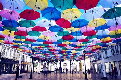 Umbrellas as a roof on a plaza.